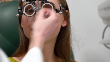 Woman at the reception of an ophthalmologist. Eye examination and selection of spectacle lenses video