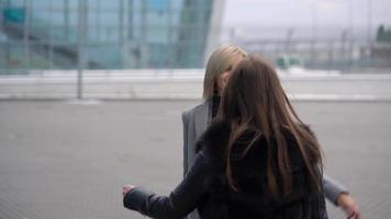 Long-awaited meeting of two friends at the airport. Slow motion video