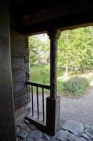 view from the historic wooden porch to the green backyard photo