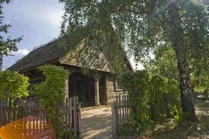 old historic wooden country cottage on a sunny day in Podlasie, Poland photo