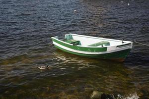 empty rowing boat on the water on a summer day photo