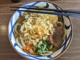 Close up of beef Udon with hot chili spicy and curry soup. The photo is suitable to use for Japan traditional food background, poster and food content media.