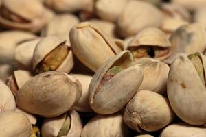 Pistachios macro on texture background. Tasty pistachios as background photo