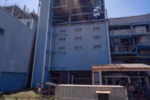 aerial view of combine cycle project power plant when day time with blue sky and cloudy vibes. The photo is suitable to use for industry background photography, power plant poster and electricity.