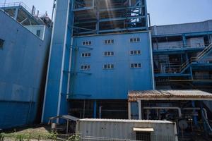 aerial view of combine cycle project power plant when day time with blue sky and cloudy vibes. The photo is suitable to use for industry background photography, power plant poster and electricity .