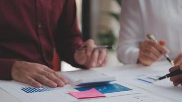 Financial analysts analyze business financial reports on a digital tablet planning investment project during a discussion at a meeting of corporate showing the results of their successful teamwork. video