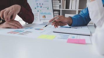Financial analysts analyze business financial reports on a digital tablet planning investment project during a discussion at a meeting of corporate showing the results of their successful teamwork. video
