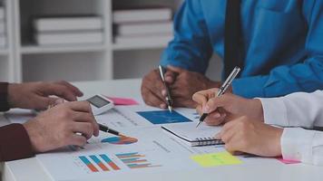 Financial analysts analyze business financial reports on a digital tablet planning investment project during a discussion at a meeting of corporate showing the results of their successful teamwork. video