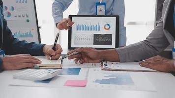 Financial analysts analyze business financial reports on a digital tablet planning investment project during a discussion at a meeting of corporate showing the results of their successful teamwork. video