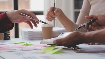 Financial analysts analyze business financial reports on a digital tablet planning investment project during a discussion at a meeting of corporate showing the results of their successful teamwork. video