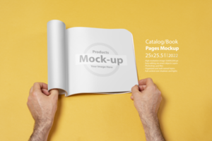 Male hand opened a presentation catalog on yellow backdrop psd