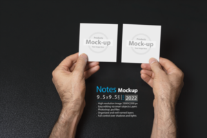 hand holding two blank notes paper or image frame on dark background psd