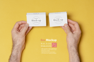 A man hands comparing two pillboxes in front of yellow background psd