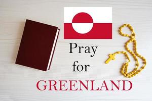 Pray for Greenland. Rosary and Holy Bible background. photo