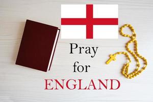 Pray for England. Rosary and Holy Bible background. photo