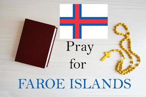 Pray for Faroe Islands. Rosary and Holy Bible background. photo