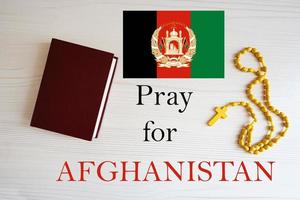 Pray for Afghanistan. Rosary and Holy Bible background. photo