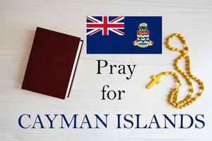 Pray for Cayman Islands. Rosary and Holy Bible background. photo
