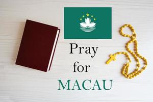 Pray for Macau. Rosary and Holy Bible background. photo