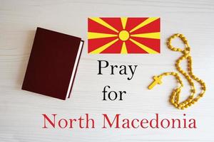 Pray for North Macedonia. Rosary and Holy Bible background. photo