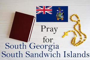 Pray for South Georgia and South Sandwich Islands. Rosary and Holy Bible background. photo