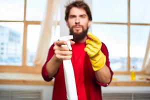 Cheerful male cleaning professional household cleaning service photo