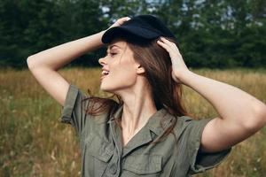 Woman in a cap on the meadow and green shirt photo