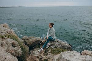 beautiful woman sweaters cloudy sea admiring nature Relaxation concept photo