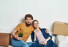 cheerful young couple boxes with things interior room tools moving photo
