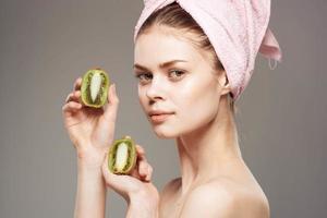 beautiful woman naked shoulders spa treatments kiwi in hands natural cosmetics photo