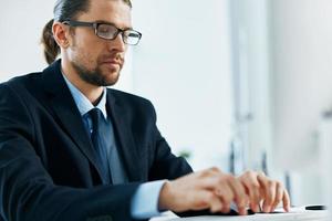 male manager at his desk working in front of a computer photo