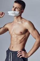 sports man with bare shoulders medical health mask gym photo