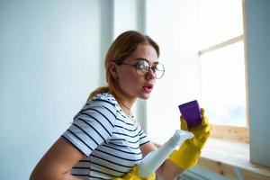 cleaning lady with a sponge in her hands home care service detergent window cleaning photo