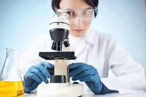 Woman in white coat laboratory microscope work science research photo