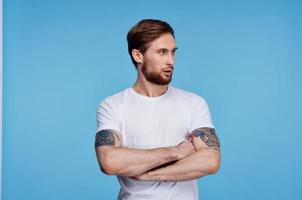 Cheerful man in white t-shirt tattoo on his arms cropped view fashion photo