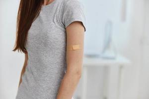 woman hospital with adhesive plaster on shoulder immunity medicine passport photo