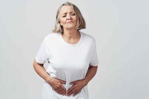 woman is holding her belly diarrhea health problems photo