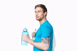 sport man with tattoo on his arm workout water bottle cropped view light background photo