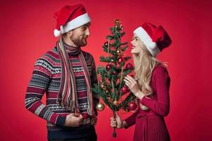 portrait of married couple christmas holiday red background photo