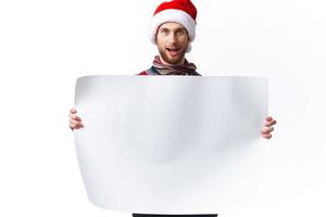 Cheerful man in a christmas hat with white mockup poster christmas copy-space studio photo