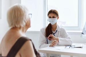 elderly woman patient on examination by a nurse health care photo