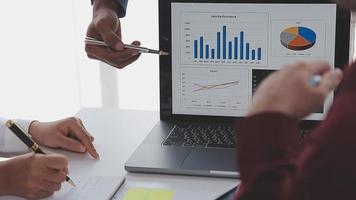 Financial analysts analyze business financial reports on a digital tablet planning investment project during a discussion at a meeting of corporate showing the results of their successful teamwork. video