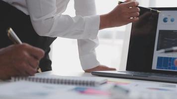 Financial analysts analyze business financial reports on a digital tablet planning investment project during a discussion at a meeting of corporate showing the results of their successful teamwork. video