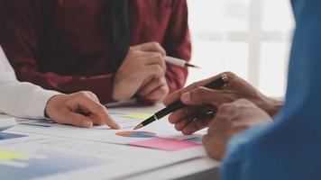 Financial analysts analyze business financial reports on a digital tablet planning investment project during a discussion at a meeting of corporate showing the results of their successful teamwork. video