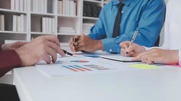 Financial analysts analyze business financial reports on a digital tablet planning investment project during a discussion at a meeting of corporate showing the results of their successful teamwork. video