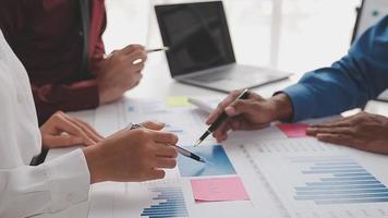 Financial analysts analyze business financial reports on a digital tablet planning investment project during a discussion at a meeting of corporate showing the results of their successful teamwork. video