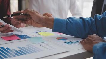 Financial analysts analyze business financial reports on a digital tablet planning investment project during a discussion at a meeting of corporate showing the results of their successful teamwork. video