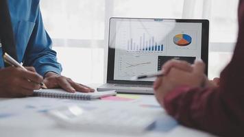 Financial analysts analyze business financial reports on a digital tablet planning investment project during a discussion at a meeting of corporate showing the results of their successful teamwork. video