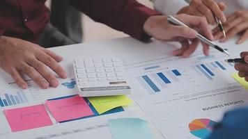 Financial analysts analyze business financial reports on a digital tablet planning investment project during a discussion at a meeting of corporate showing the results of their successful teamwork. video