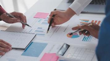 Financial analysts analyze business financial reports on a digital tablet planning investment project during a discussion at a meeting of corporate showing the results of their successful teamwork. video